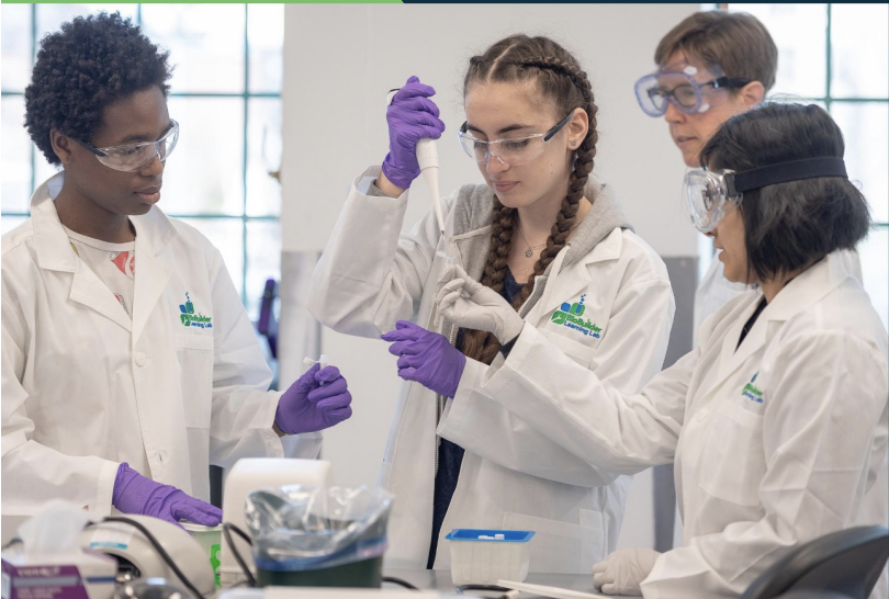 A group of students using lab equipment