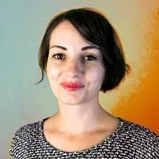 Photo of Julie Legault, a light-skinned person with brown hair in a bob and bright lipstick