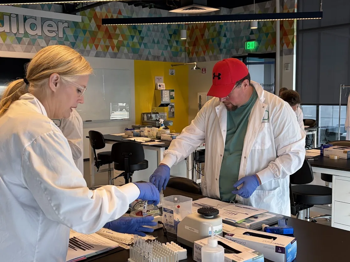 A teacher looking intently at a lab activity